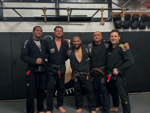 Dave Dempsey (Foxhole Board of Director & Currently in the Navy [on the far right]) earned his black belt professor bars and Modesto De La O [standing next to him] earned his brown belt.